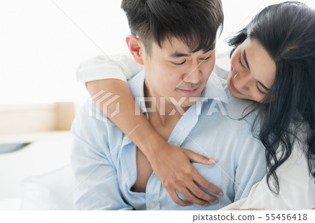 Couple sits on bed, they hug each other by love.. 55456418