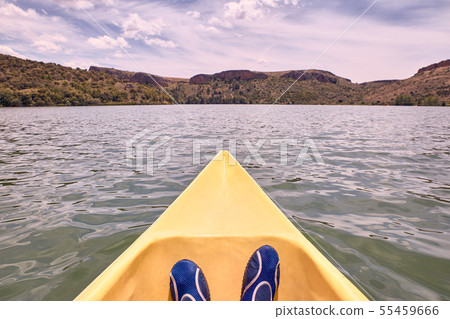 View of feet of man while kayaking on the river 55459666