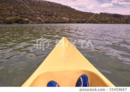 View of feet of man while kayaking on the river 55459667