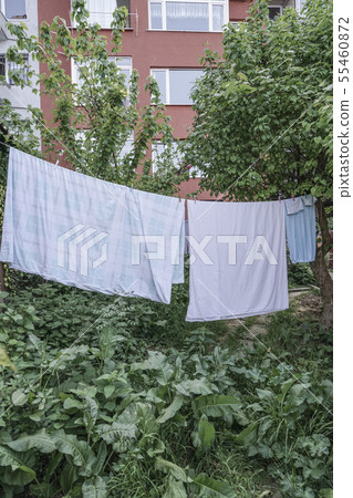 hanged clothes at garden of an building 55460872