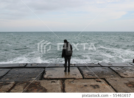 man standing against the sea man standing against the sea 55461657