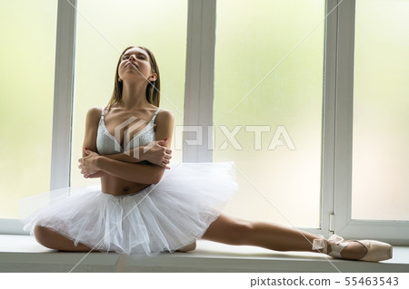Ballet dancer sitting on window sill shot 55463543