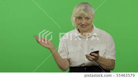 An elderly woman adjusts her clothes and smiles. Chroma key An elderly woman adjusts her clothes and smiles. Chroma key 55463579