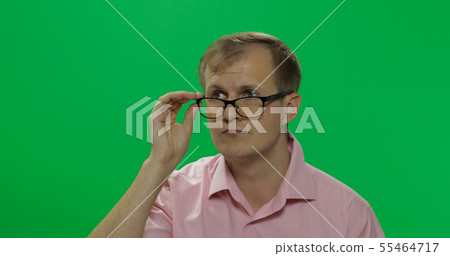 Handsome thoughtful man in pink shirt thinks about something. Chroma key 55464717