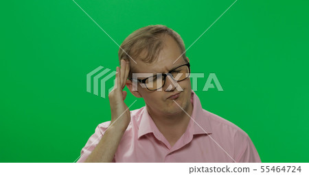 Handsome man in pink shirt has a headache. Chroma key 55464724