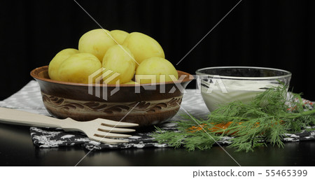 Boiled new delicious potato on plate with fresh dill on table ready to eat 55465399