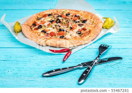 Vegetarian pizza with vegetables on blue table. 55467281