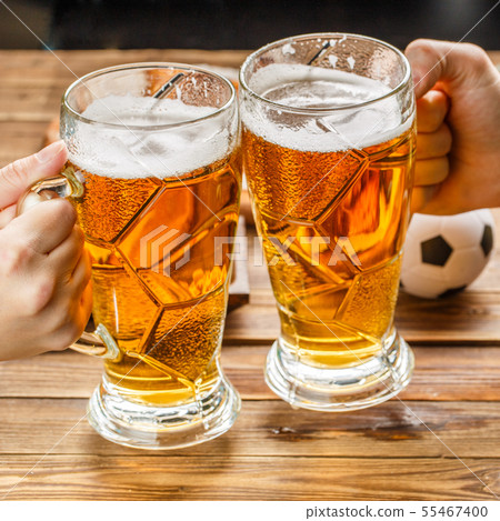 Appetizers and beer on the table for watch the football match. Appetizers and beer on the table for watch the football match. 55467400