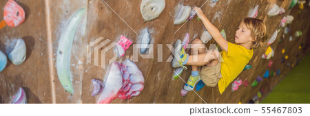 little boy climbing a rock wall in special boots. indoor BANNER, LONG FORMAT little boy climbing a rock wall in special boots. indoor BANNER, LONG FORMAT 55467803