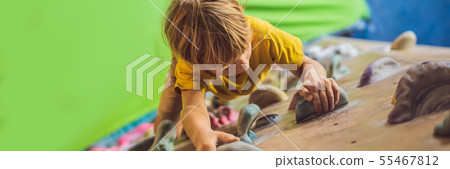 little boy climbing a rock wall in special boots. indoor BANNER, LONG FORMAT little boy climbing a rock wall in special boots. indoor BANNER, LONG FORMAT 55467812