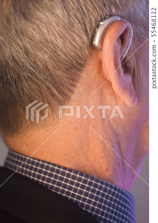 Man with hearing aid 55468112