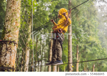 Little boy in a rope park. Active physical recreation of the child in the fresh air in the park Little boy in a rope park. Active physical recreation of the child in the fresh air in the park 55468845