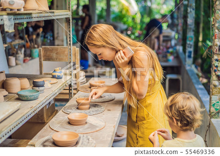 mother and son doing ceramic pot in pottery workshop 55469336