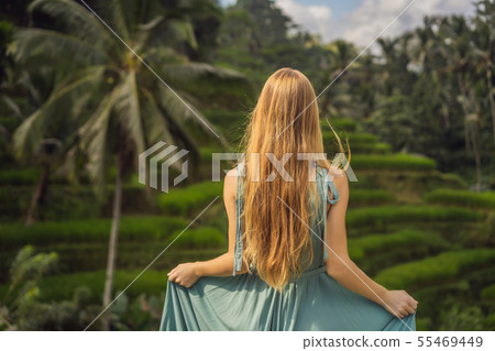 Beautiful young woman walk at typical Asian hillside with rice farming, mountain shape green cascade Beautiful young woman walk at typical Asian hillside with rice farming, mountain shape green cascade 55469449