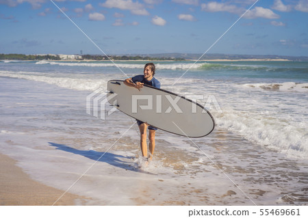 Surfer with his surfboard running to the waves Surfer with his surfboard running to the waves 55469661