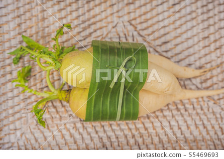Eco-friendly product packaging concept. Vegetables wrapped in a banana leaf, as an alternative to a Eco-friendly product packaging concept. Vegetables wrapped in a banana leaf, as an alternative to a 55469693
