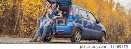 BANNER, LONG FORMAT Dad and son are resting on the side of the road on a road trip. Road trip with 55469879