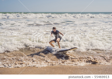 Surfer with his surfboard running to the waves 55469913