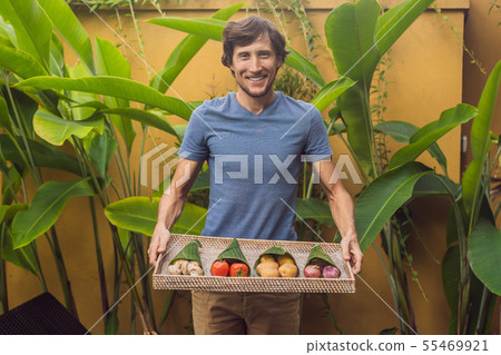 Eco-friendly product packaging concept. Vegetables wrapped in a banana leaf, as an alternative to a Eco-friendly product packaging concept. Vegetables wrapped in a banana leaf, as an alternative to a 55469921