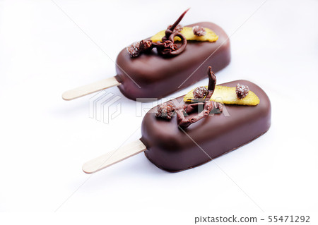 Chocolate glazed peach ice cream popsicles with chocolate decoration 55471292