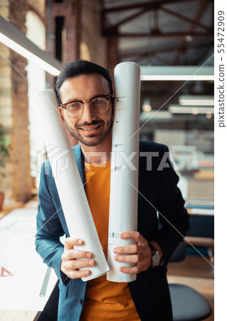 Interior designer wearing jacket standing in spacious office 55472909