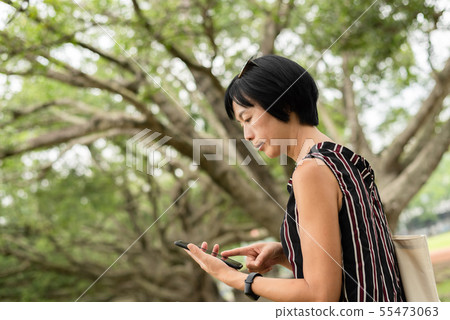 woman stand on a stairs and use cellphone 55473063