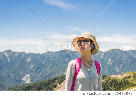 Asian mountain climbing woman 55473072