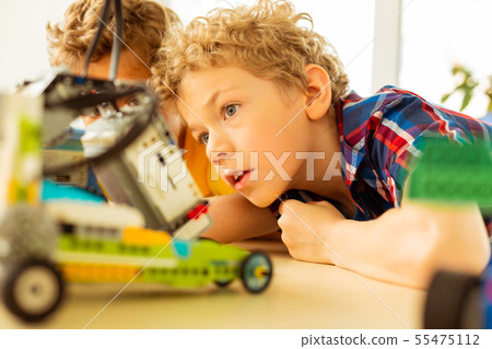 Smart excited boy being curious about robotics Smart excited boy being curious about robotics 55475112
