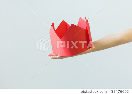 Fake paper crown in boy hands. Caricature concept Fake paper crown in boy hands. Caricature concept 55476692