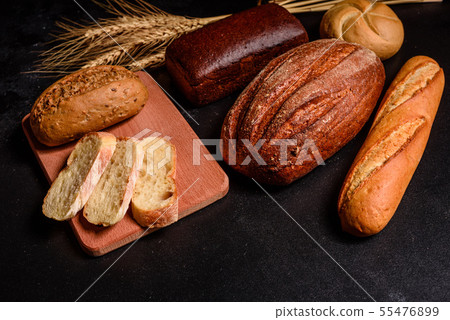 Fresh fragrant bread with grains and cones  55476899