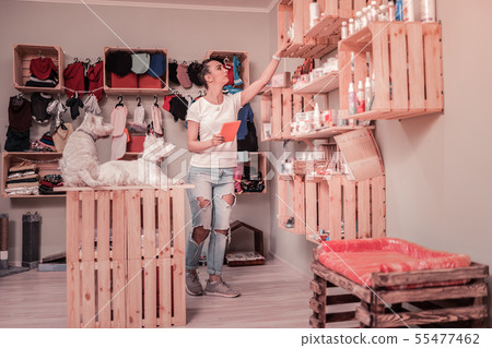 Dark-haired woman loving pets working in the shop for pets 55477462