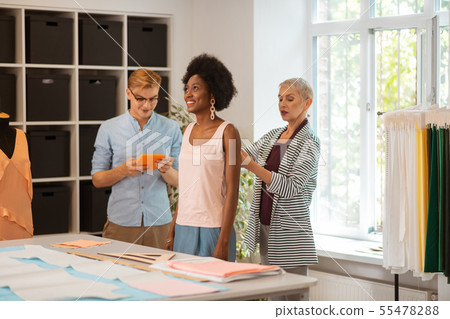 Smiling pretty young girl standing in a workshop 55478288