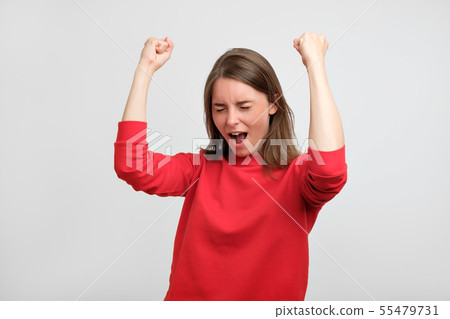 happy caucasian woman in red sweater exults happy caucasian woman in red sweater exults 55479731