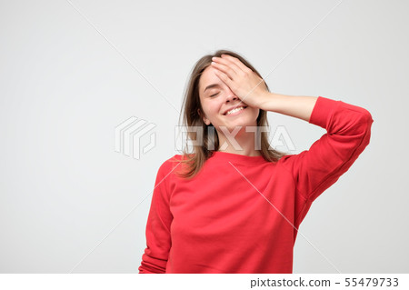 Pleased Caucasian woman wearing red sweater Pleased Caucasian woman wearing red sweater 55479733
