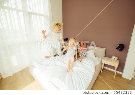 Nice positive boy jumping with his sister 55482336