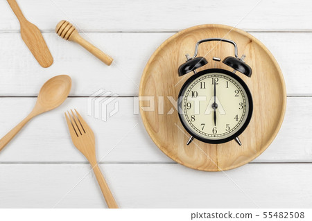 Top view of a wooden dish and eating utensils 55482508