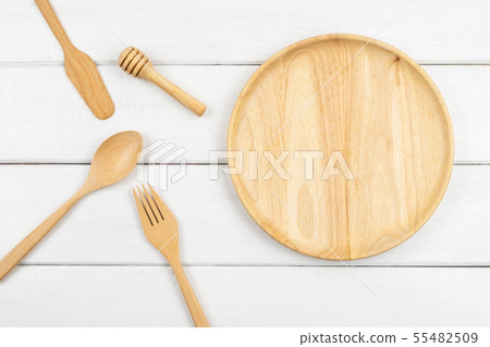 Top view of a wooden dish with eating utensils Top view of a wooden dish with eating utensils 55482509