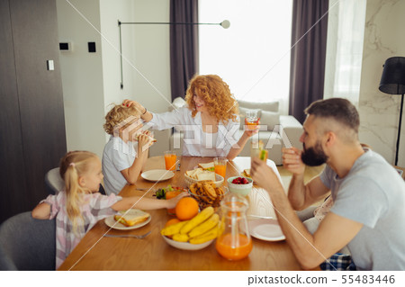 Joyful nice woman touching her sons hair Joyful nice woman touching her sons hair 55483446