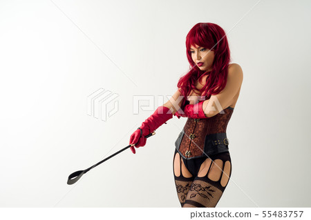 Dominant woman in a red wig corset and leather 55483757