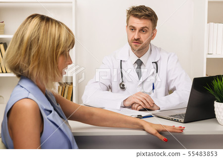 Young woman on a consultation with a male surgeon 55483853
