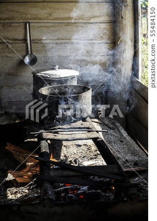 cooking in saucepans on an improvised stove over a 55484150