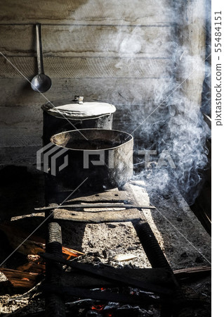 cooking in saucepans on an improvised stove over a cooking in saucepans on an improvised stove over a 55484151