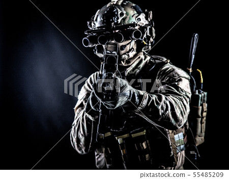 Army soldier aiming rifle in camera in darkness Army soldier aiming rifle in camera in darkness 55485209