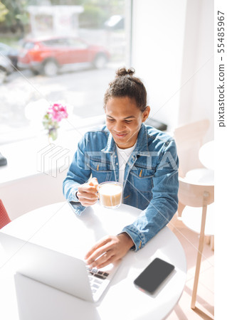 Cheerful male person spending morning in cafe 55485967