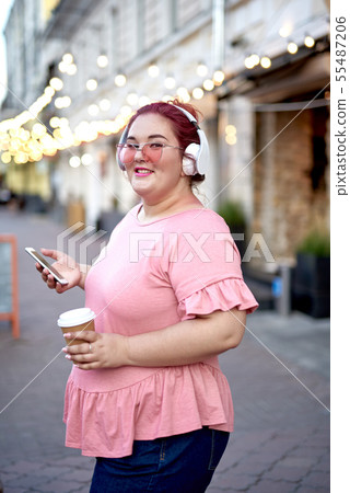Fat young woman with smartphone and coffee Fat young woman with smartphone and coffee 55487206