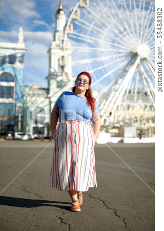 Young fat woman walking in the city 55488302