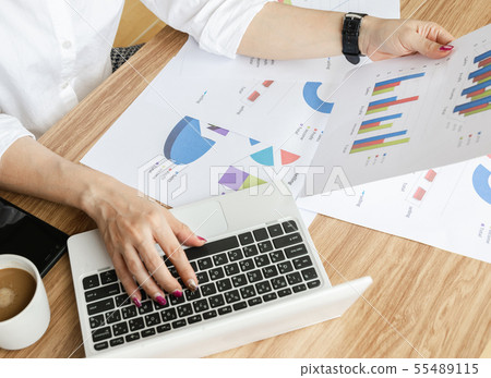 Business team work analyzing charts and graphs 55489115