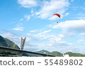 Paragliding with the blue sky in the background. 55489802