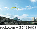 Paragliding with the blue sky in the background. 55489803