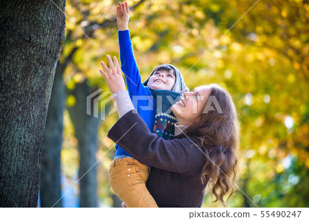 Cute, happy, boy smiling and hugging with his mom 55490247
